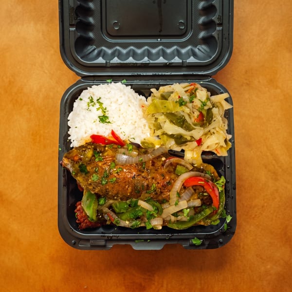 A takeout meal featuring rice, seasoned fish with peppers and onions, and sautéed cabbage.